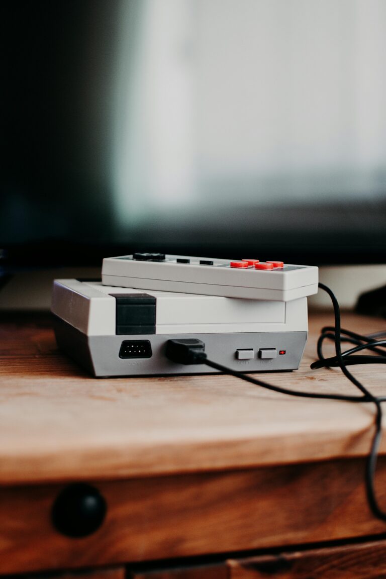 Super Nintendo Entertainment System console on side board with wires plugged in