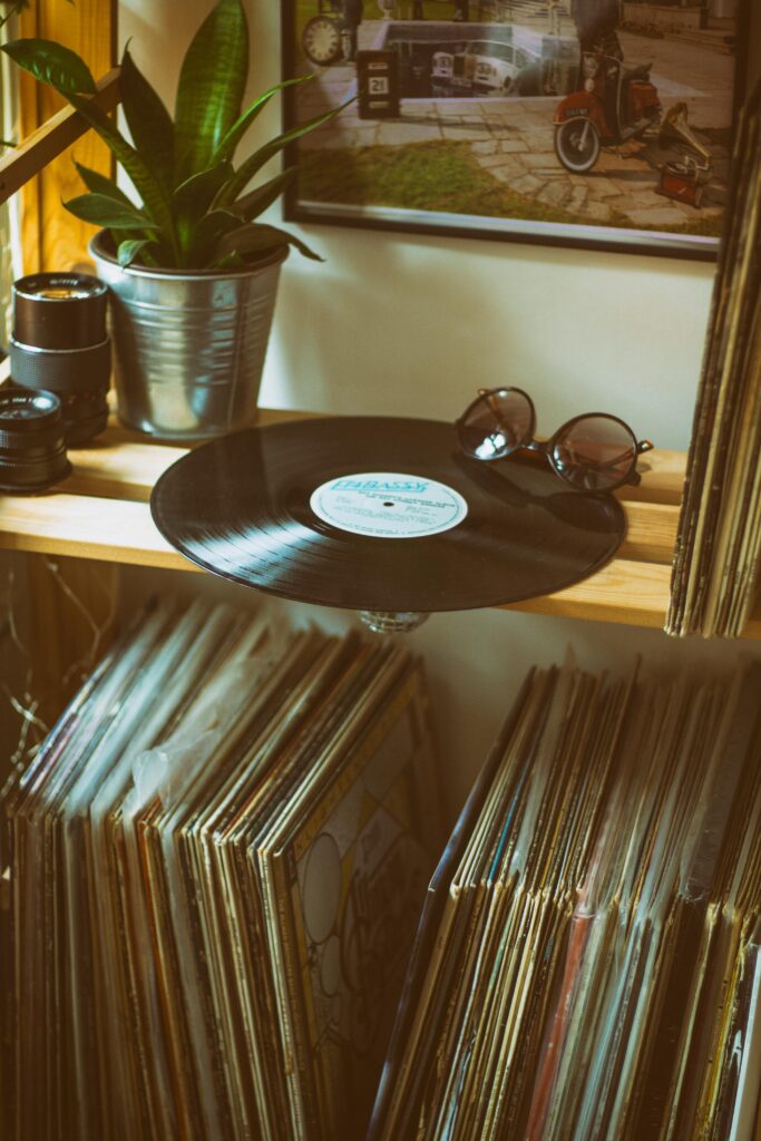 Various vinyl records underneath a vinyl record player